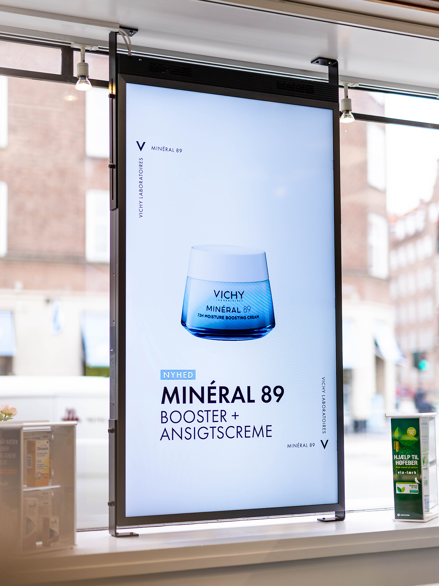 reklamer for Vichy på digitale skaerme i vinduet